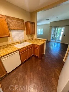 a kitchen with stainless steel appliances granite countertop a sink stove and wooden floor