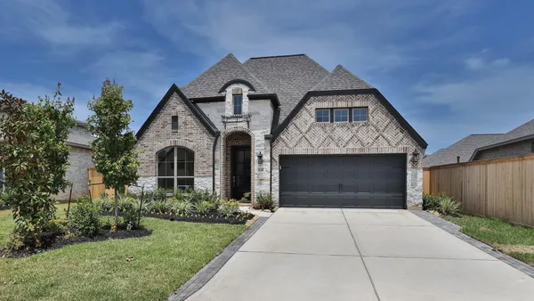 a front view of a house with yard