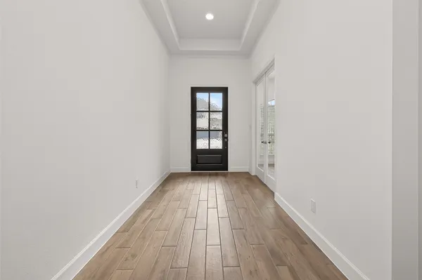 a view of a hallway with wooden floor