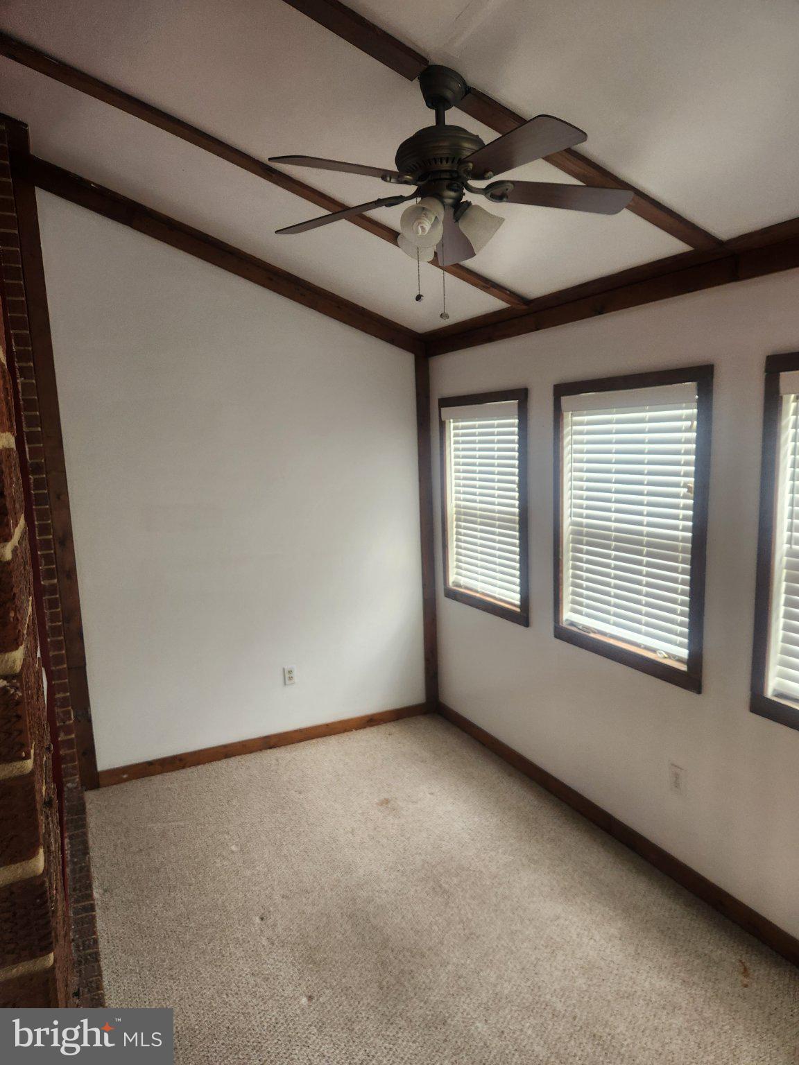 2760 Yarnall Road Baltimore, MD 21227 - Photo 18 of 22 a view of a livingroom with a ceiling fan and window