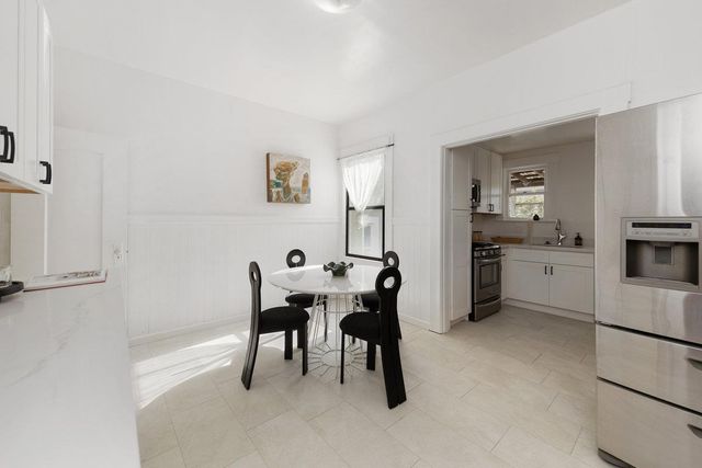 a kitchen with a table and chairs