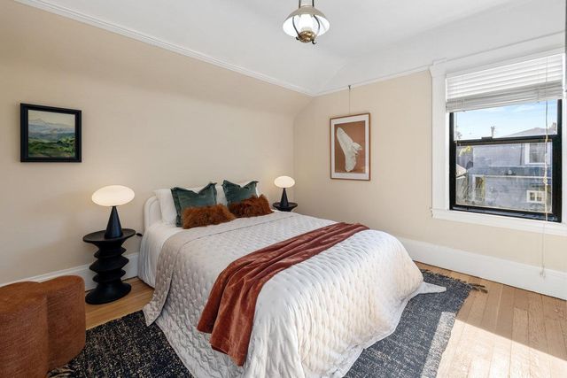 a bedroom with bed and a night stand