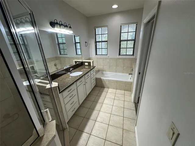 a bathroom with a sink a mirror and a bathtub