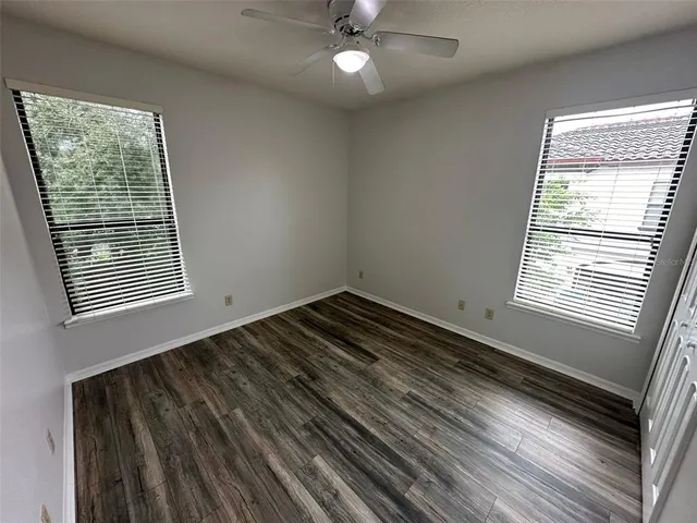 a view of a room with wooden floor and fan