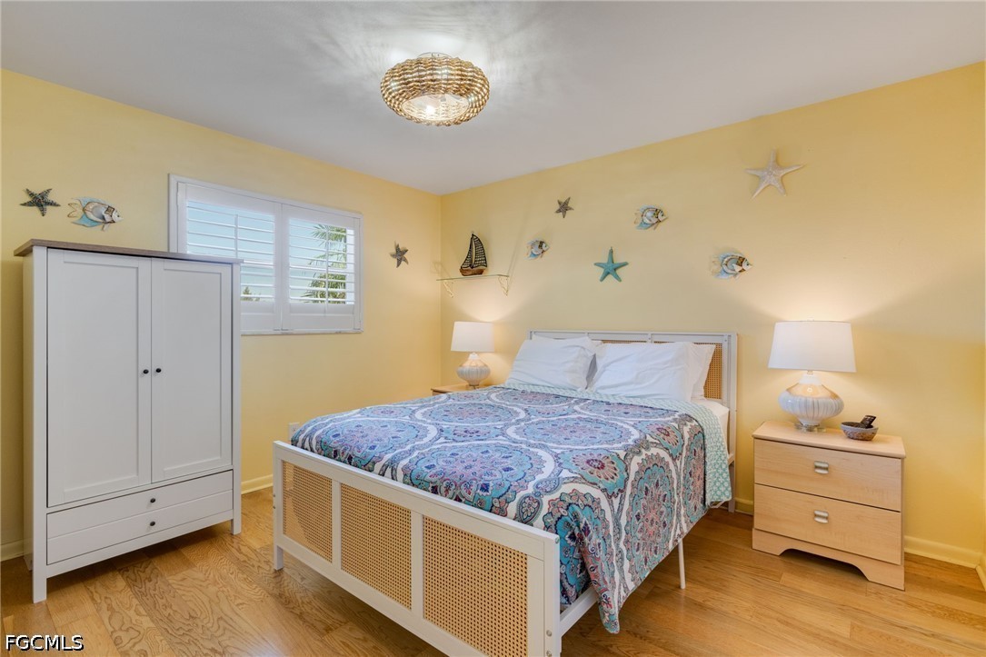 2912 Southwest 1st Terrace Cape Coral, FL 33991 - Photo 15 of 31 a spacious bedroom with a bed and a table in it