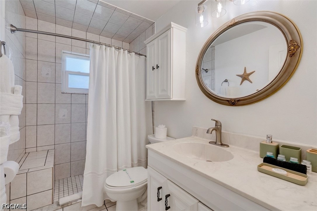 2912 Southwest 1st Terrace Cape Coral, FL 33991 - Photo 16 of 31 a bathroom with a sink a toilet and a mirror