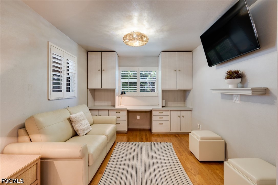 2912 Southwest 1st Terrace Cape Coral, FL 33991 - Photo 17 of 31 a living room with furniture and a flat screen tv