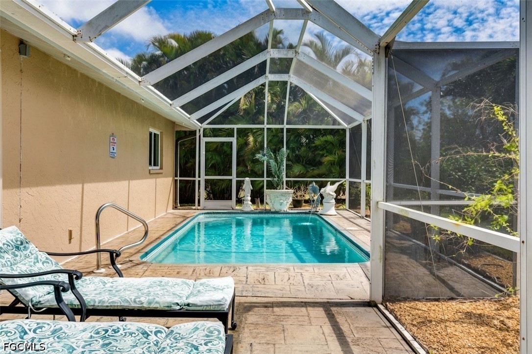 2912 Southwest 1st Terrace Cape Coral, FL 33991 - Photo 19 of 31 a view of a house with a swimming pool and sitting area