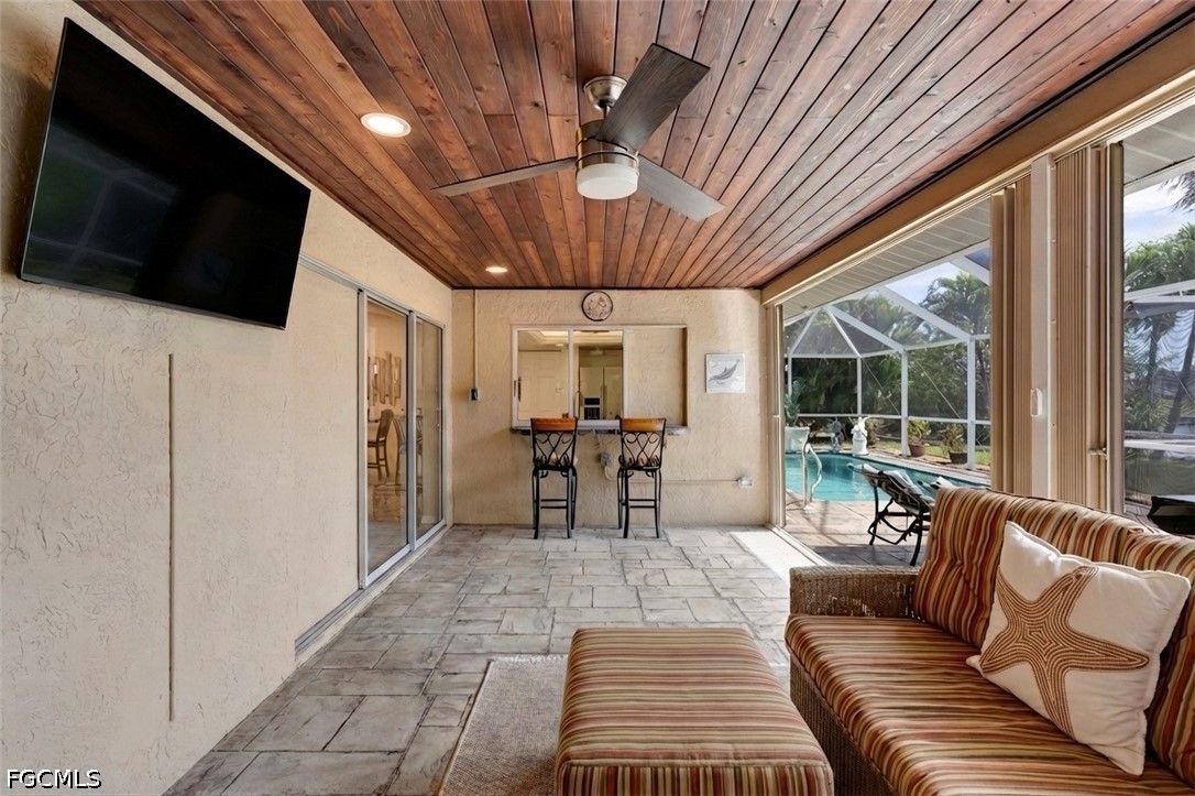 2912 Southwest 1st Terrace Cape Coral, FL 33991 - Photo 22 of 31 a living room with furniture a flat screen tv and a large window