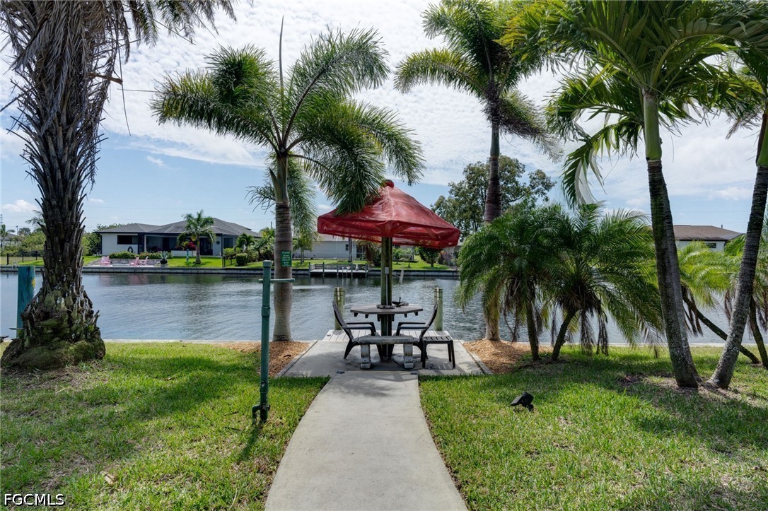 2912 Southwest 1st Terrace Cape Coral, FL 33991 - Photo 24 of 31 a view of swimming pool with a table and chairs