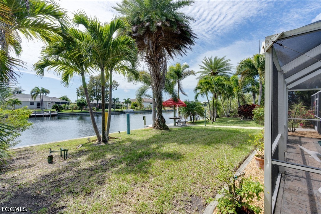 2912 Southwest 1st Terrace Cape Coral, FL 33991 - Photo 25 of 31 a swimming pool with lots of palm trees