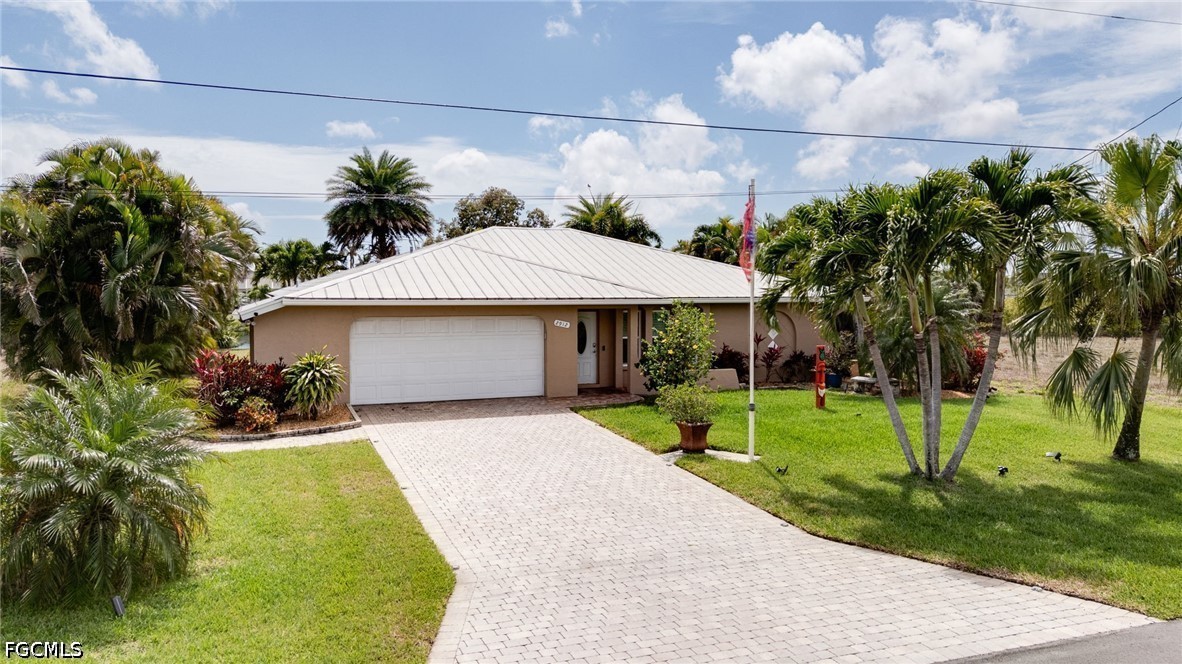 2912 Southwest 1st Terrace Cape Coral, FL 33991 - Photo 31 of 31 a front view of a house with a yard and garage