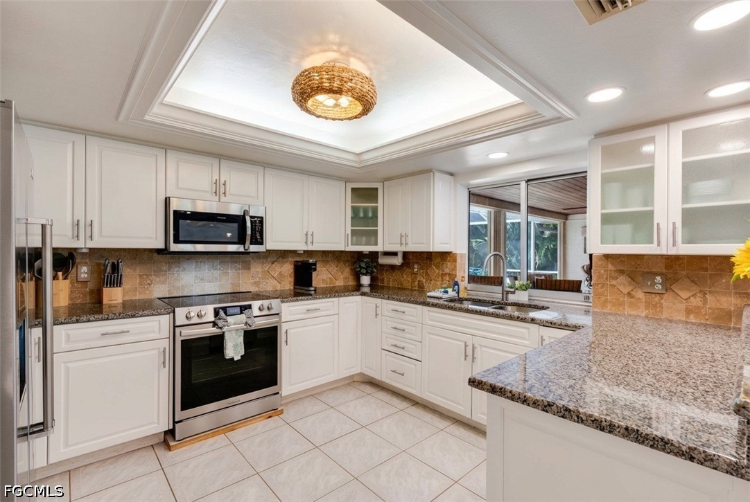 2912 Southwest 1st Terrace Cape Coral, FL 33991 - Photo 5 of 31 a kitchen with stainless steel appliances granite countertop a sink and cabinets