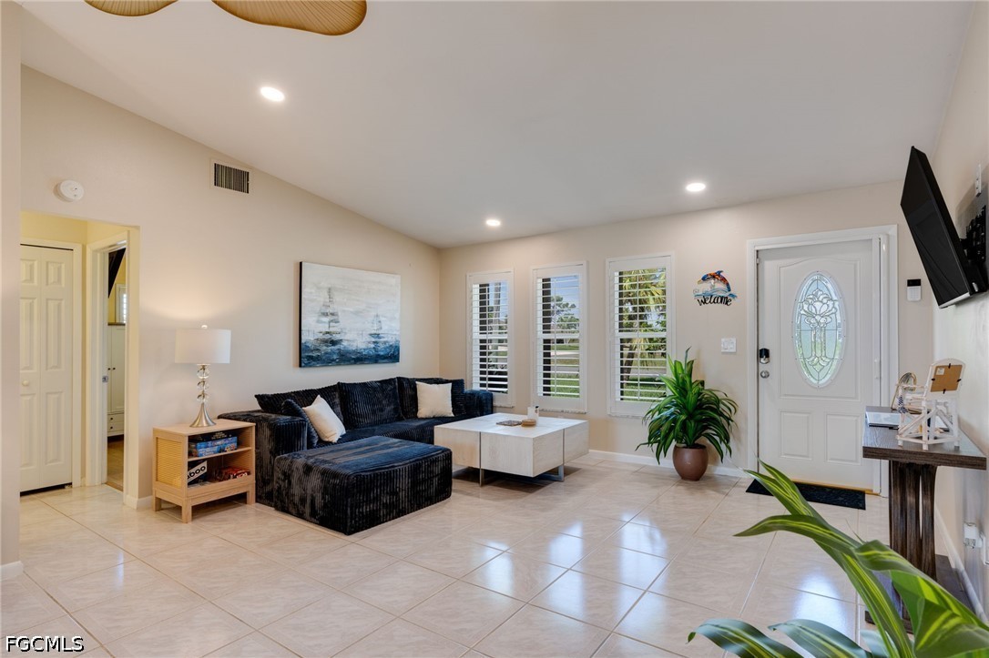 2912 Southwest 1st Terrace Cape Coral, FL 33991 - Photo 7 of 31 a living room with furniture and a flat screen tv