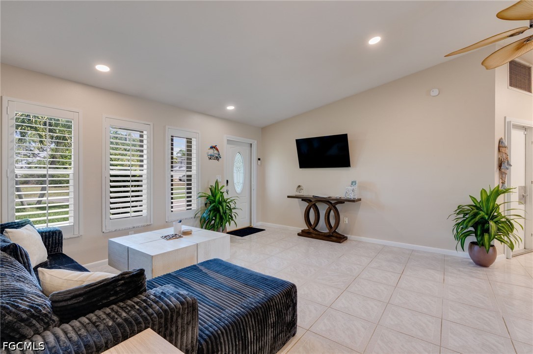 2912 Southwest 1st Terrace Cape Coral, FL 33991 - Photo 9 of 31 a living room with furniture and a flat screen tv