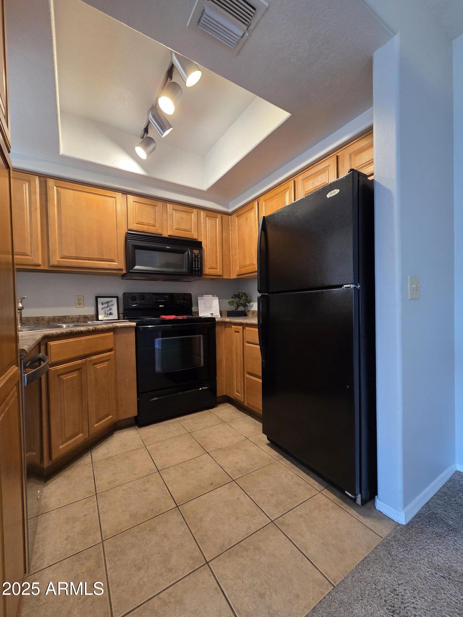 1825 West Ray Road, Unit 2031 Chandler, AZ 85224 - Photo 1 of 21 a kitchen with stainless steel appliances granite countertop a refrigerator and a stove top oven