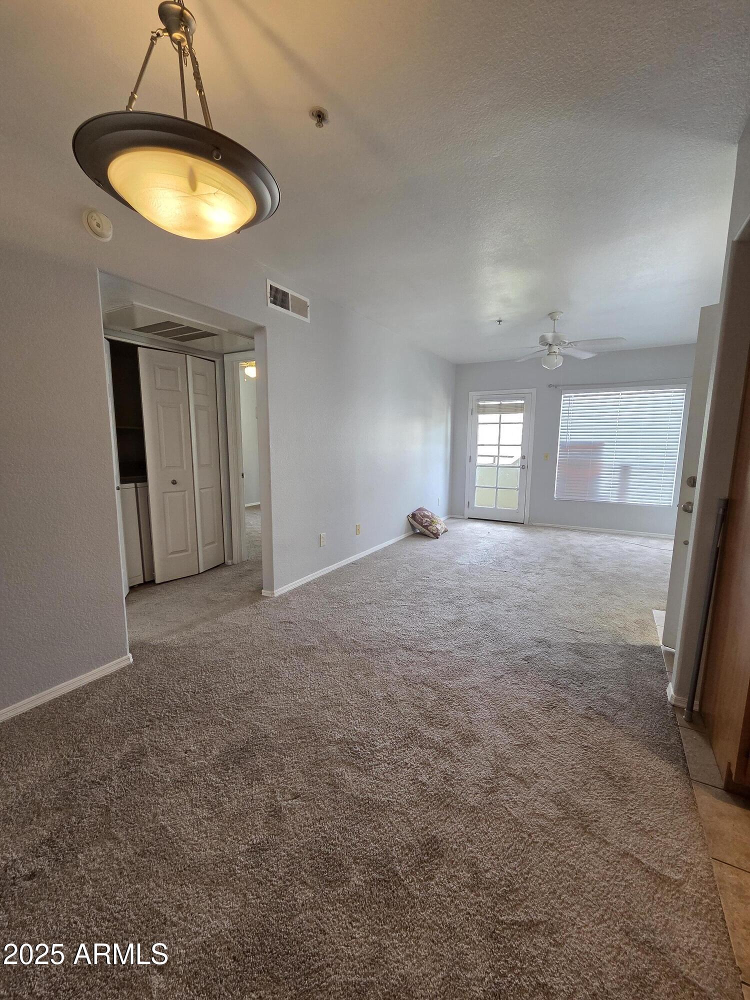 1825 West Ray Road, Unit 2031 Chandler, AZ 85224 - Photo 3 of 21 a view of a room with window and chandelier fan