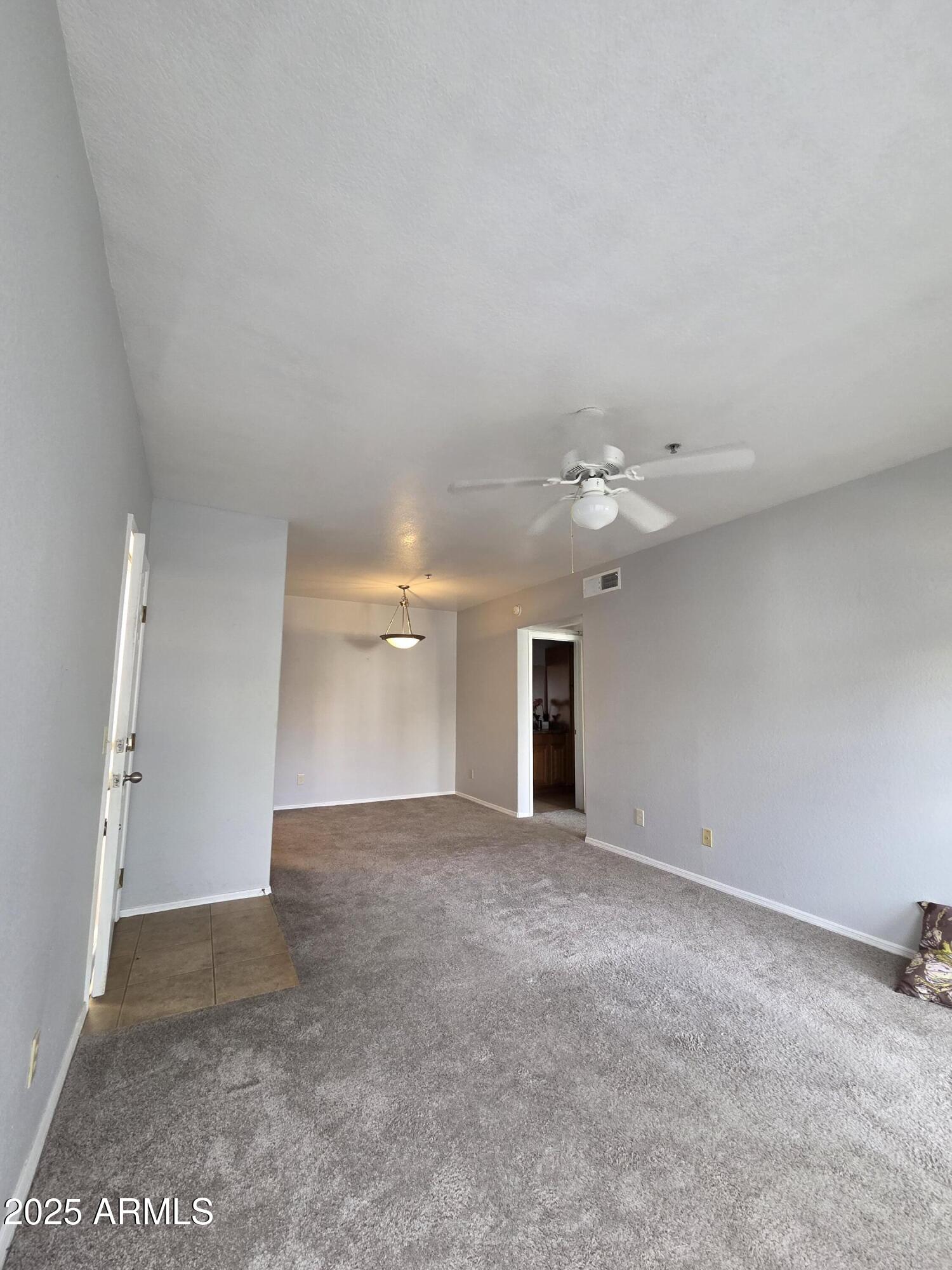 1825 West Ray Road, Unit 2031 Chandler, AZ 85224 - Photo 5 of 21 an empty room with a bathroom and a ceiling fan