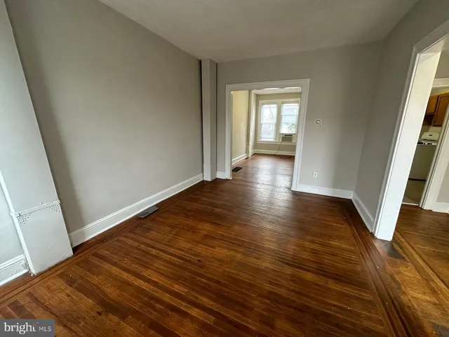 a view of wooden floor and windows in a room
