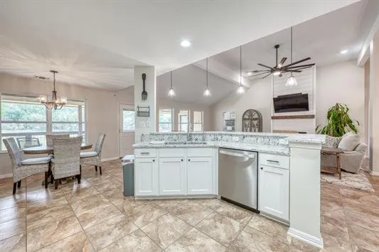 a view of a tennis ground with large trees