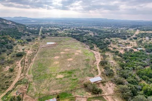an aerial view of residential houses with outdoor space