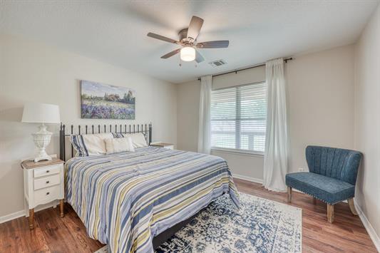 395 Lehne Loop Buchanan Dam, TX 78609 - Photo 21 of 27 a bedroom with a large bed and a chair