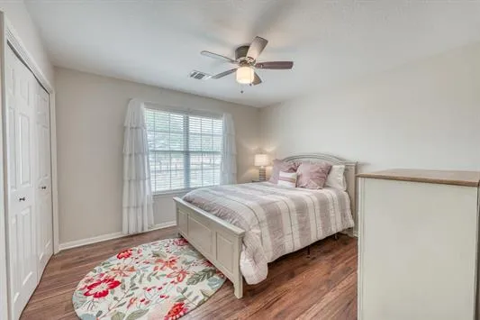 a bathroom with a granite countertop sink mirror vanity and toilet