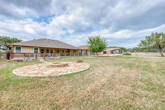 a view of a house with swimming pool and sitting area