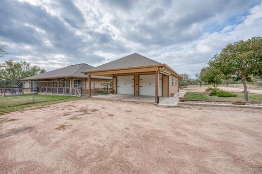 395 Lehne Loop Buchanan Dam, TX 78609 - Photo 7 of 27 a front view of a house with a garden