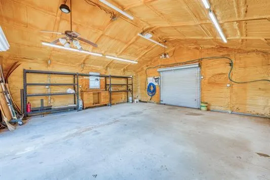 a view of a garage with wooden fence