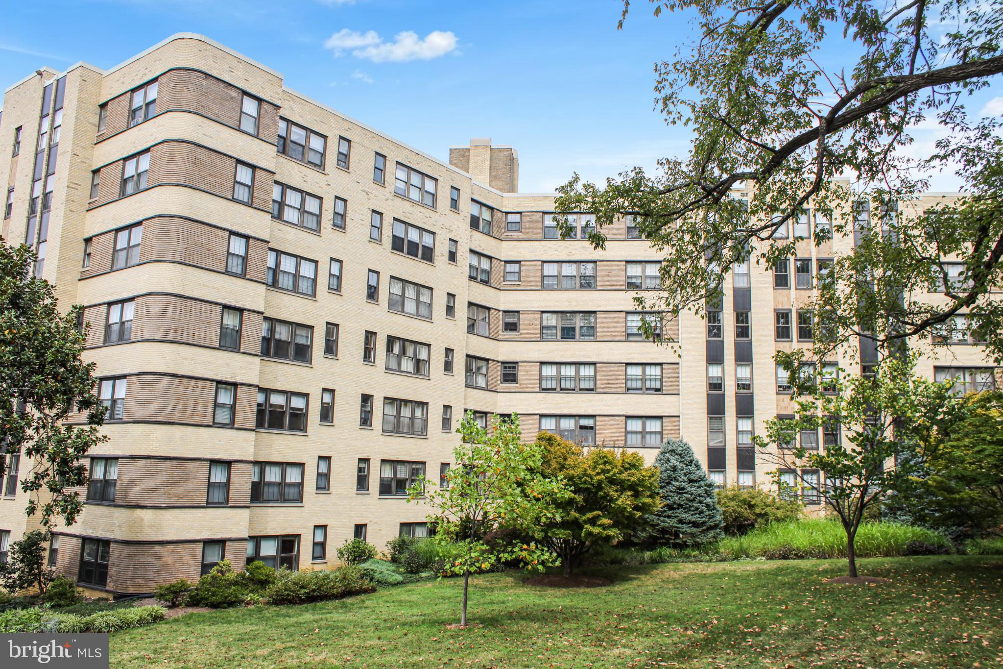 Charming apartment complex with lush greenery.