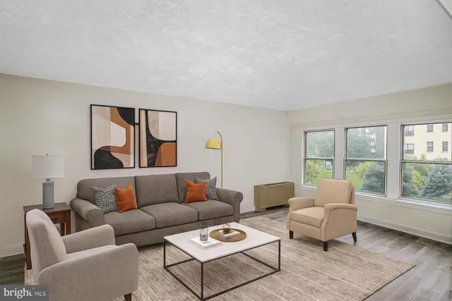 a living room with furniture and a large window