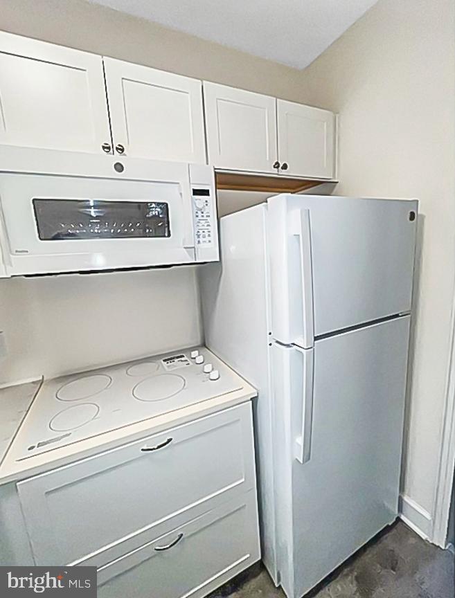 3901 Cathedral Avenue Northwest, Unit 201 Washington, DC 20016 - Photo 16 of 30 Modern kitchen with sleek white appliances.