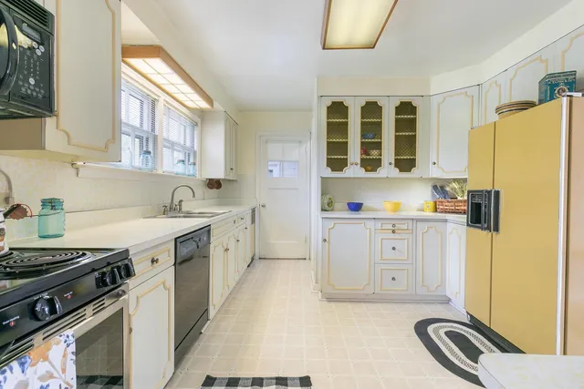 a kitchen with stainless steel appliances a stove a sink and a refrigerator