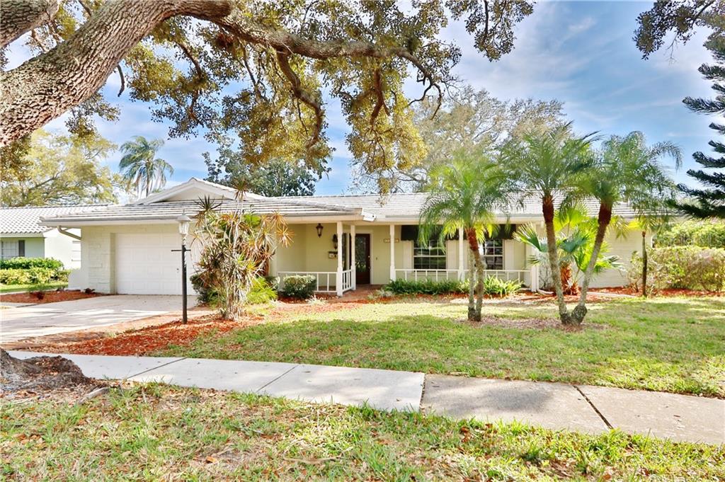 2265 Minneola Road Clearwater, FL 33764 - Photo 1 of 1 a front view of a house with a yard and garage