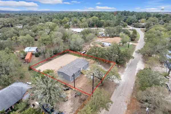 an aerial view of a house with a yard