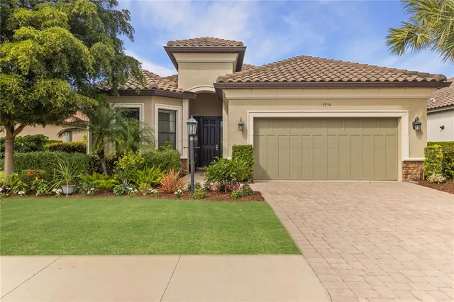 a front view of a house with a garden and plants