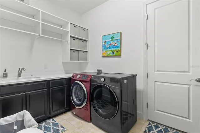 a living room with furniture kitchen view and a chandelier