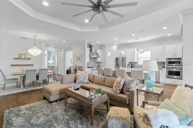 a spacious bedroom with a bed and a chandelier