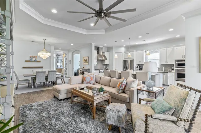 a spacious bedroom with a bed and a chandelier