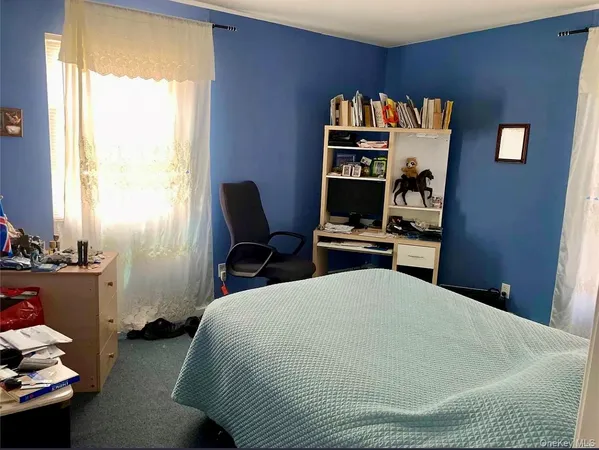 a bedroom with a bed and a book shelf