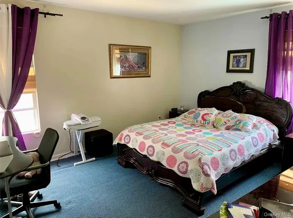 a bedroom with a bed chair and window