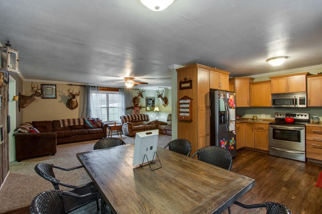 a living room with furniture kitchen view and a refrigerator