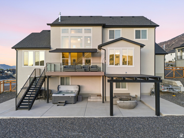 102 Elk Ridge Drive Elk Ridge, UT 84651 - Photo 51 of 61 Back of property at dusk with a patio area, stucco siding, a balcony, and a mountain view