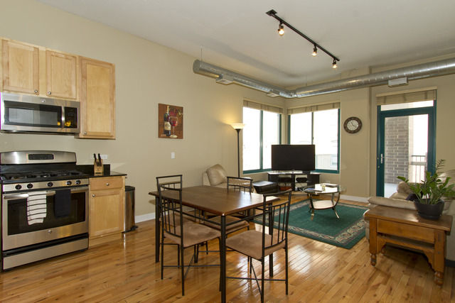 910 West Madison Street, Unit 609 Chicago, IL 60607 - Photo 2 of 12 a living room with furniture and a flat screen tv