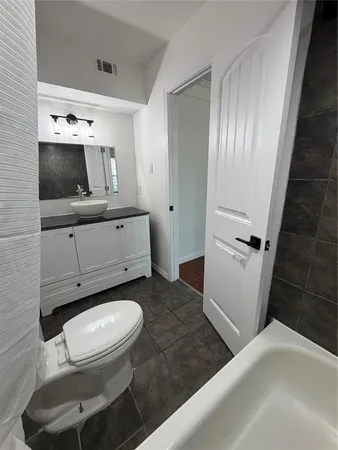 a bathroom with a toilet a sink and a mirror