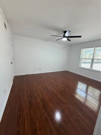 wooden floor in an empty room with a window