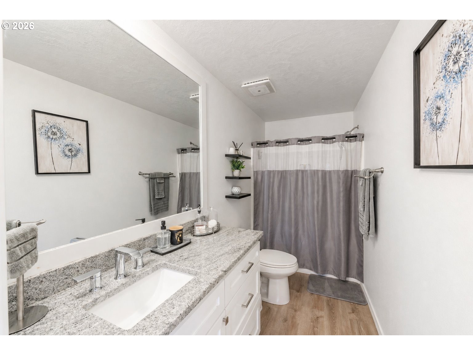 4364 Bren Loop Northeast, Unit 95 Salem, OR 97305 - Photo 17 of 34 a bathroom with a granite countertop sink a toilet a mirror and shower curtain