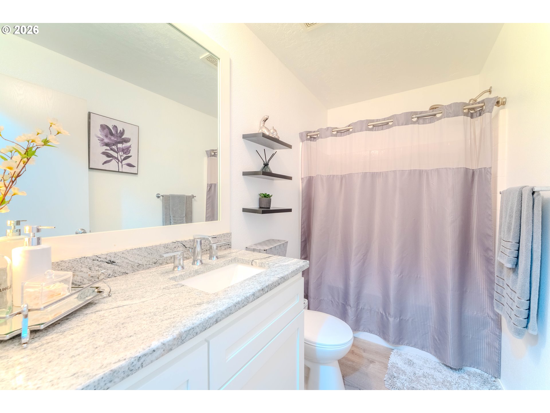 4364 Bren Loop Northeast, Unit 95 Salem, OR 97305 - Photo 18 of 34 a bathroom with a granite countertop sink and a mirror