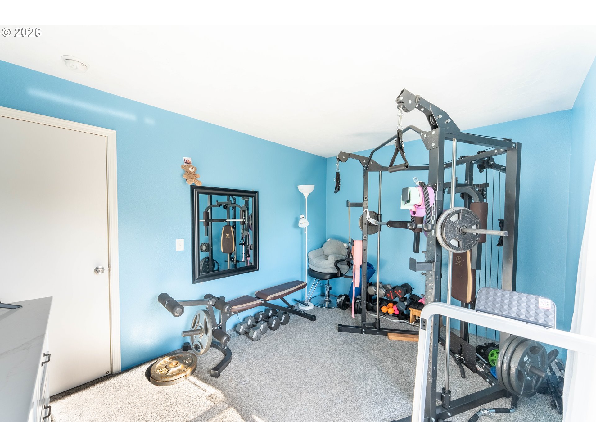 4364 Bren Loop Northeast, Unit 95 Salem, OR 97305 - Photo 22 of 34 a living room with furniture a rug and gym equipment